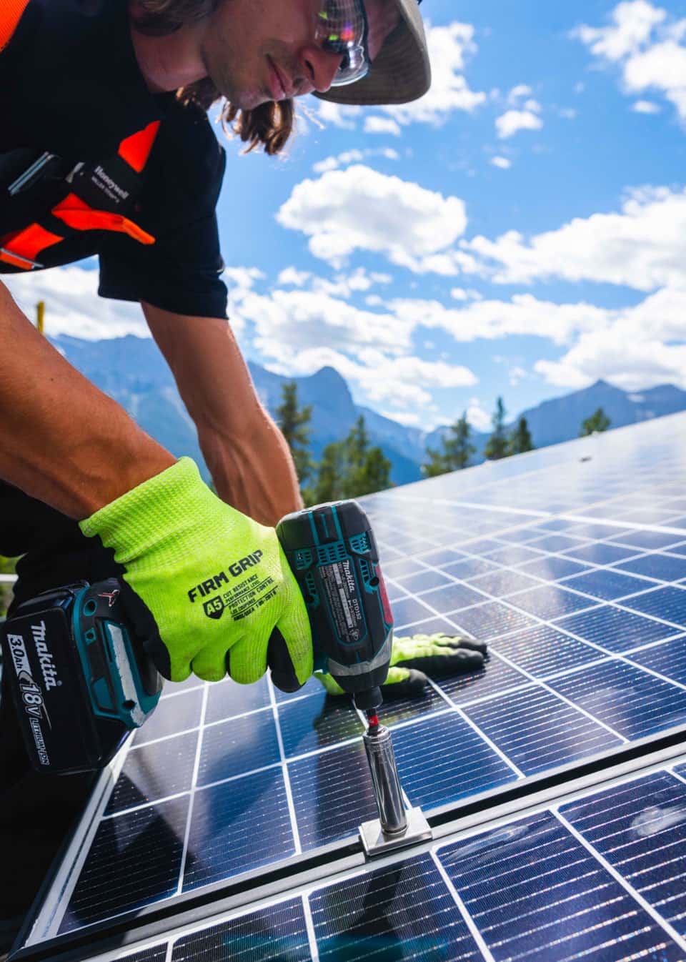 worker installing solar panel roof