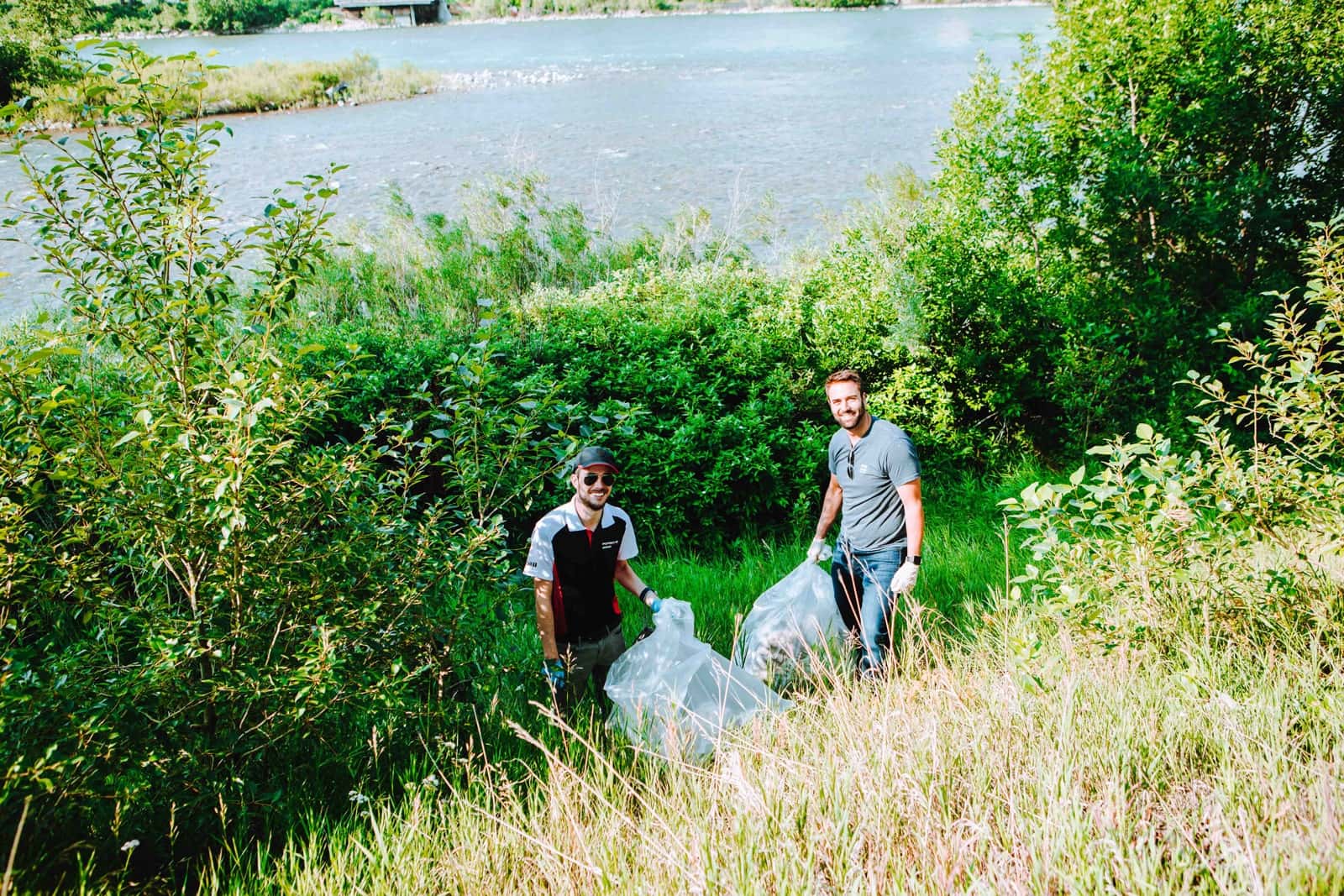 Zeno team picking up trash by the river